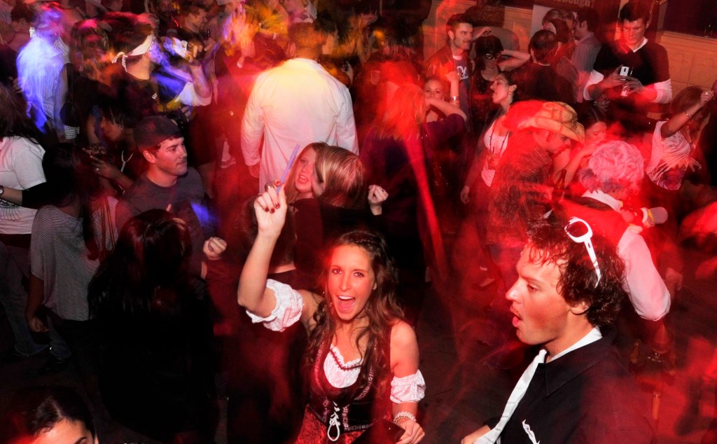 Development Coordinator for the U.S. division of Movember, Katie Thiele of Los Angeles, center bottom, dances away during the 2010 Movember Seattle Gala Parte on Saturday evening Nov. 27, 2010, at Trinity in Pioneer Square in downtown Seattle. Movember is a charity event that originated in Australia in 2003 and is growing exponentially throughout the world. As part of the fundraising challenge, men grow a mustache beginning November 1st to help raise funds for prostate and testicular cancer research. The funds go to the Livestrong Foundation and also for prostate cancer research.