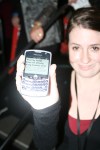 An attendee keeps up on the election results with her phone.