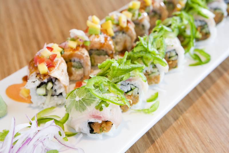 Pinto Spicy tuna, avocado, cucumber wrapped with yellow tail, cilantro, lime and jalapeno. This roll is the roll that is closet to camera.