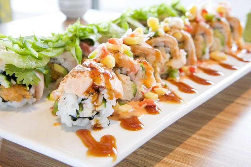 Red aE“ Mango  Red crabmeat, cucumber, and avocado topped with seared salmon, mango salsa, teriyaki and sweet mango. This roll is closest to camera