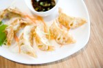 Japanese Gyoza Chicken & Vegetables dumplings pan aE“ fried in the classic tradition, served with vinaigrette soy sauce.