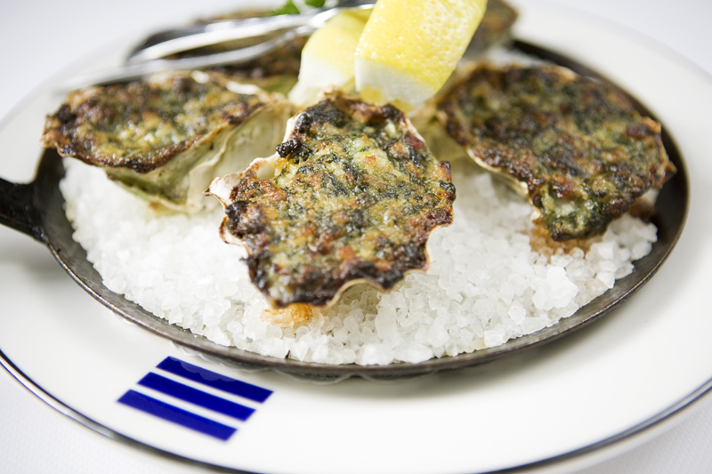 Oysters Casbarian with apple smoked bacon, wilted spinach, fennel, and anise.