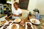 Sage Cafe owner Makini, having just set out a batch of pastries.