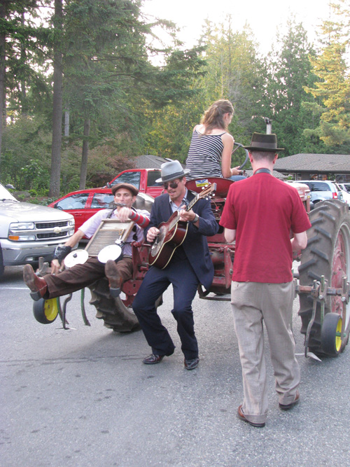 The Pied Piper of tractors leads the band, and the revelers, to the dining area.