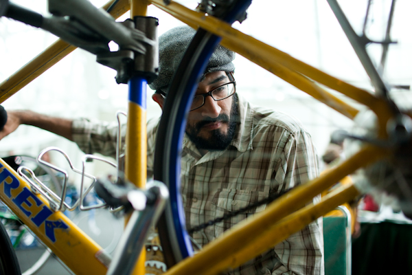 Chas Robles, an employee with Bell Town Pull Apart, fixes bicycles at the Green Festival at the Convention Center in Seattle, Wash., on Sunday, June 6, 2010.  (Photo by Matthew Williams for The Seattle Weekly)