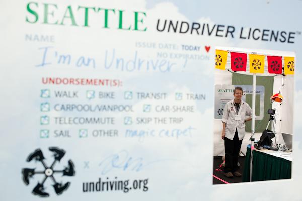 A worker waits for the next customer at the Undriving booth at the Green Festival in Seattle, Wash., on Sunday, June 6, 2010.  (Photo by Matthew Williams for The Seattle Weekly)