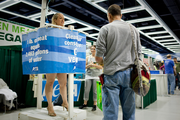 Katie Arth, the D.C. organizer for PETA, stands in a shower promoting vegan living at the Green Festival at the Convention Center in Seattle, Wash., on Sunday, June 6, 2010.  (Photo by Matthew Williams for The Seattle Weekly)