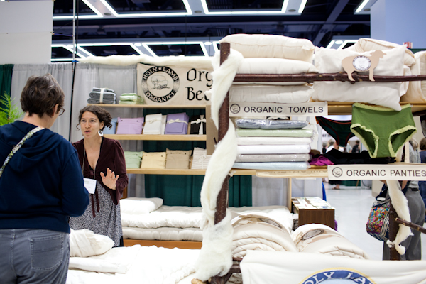 A vendor talks with potential customers during the Green Festival at the convention center in Seattle, Wash., on Sunday, June 6, 2010.  (Photo by Matthew Williams for The Seattle Weekly)
