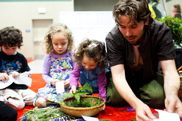 Patrick Fallon, with the Wilderness Awareness School, teaches children how to make bookmarks out of plant materials during the Green Festival in Seattle, Wash., on Sunday, June 6, 2010.  (Photo by Matthew Williams for The Seattle Weekly)