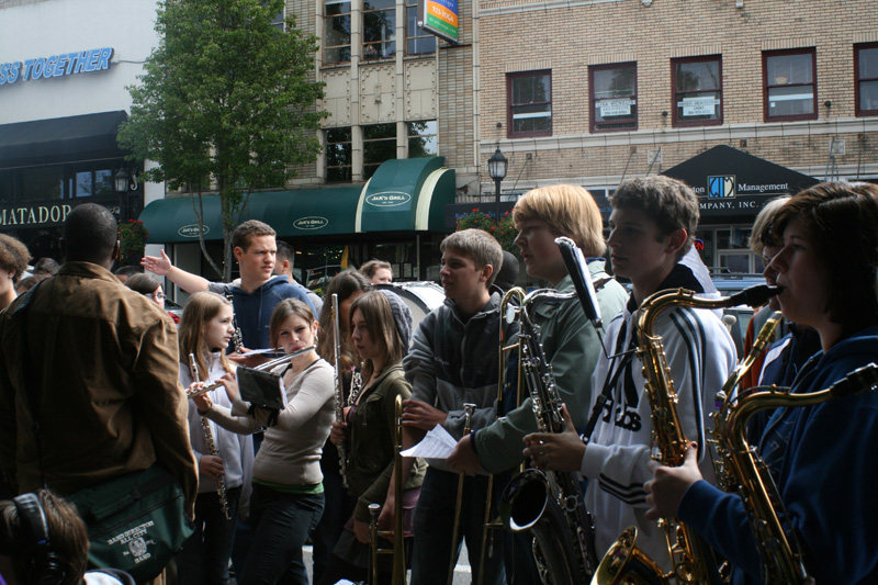 The Chief Sealth High School Marching Band warms up outside Easy Street.
