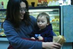Elise Tse and her 18-month old son, Torrin, get a snack on their way to the park.
