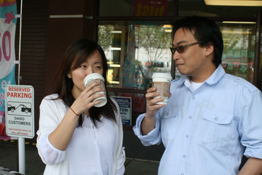Vicky Ly and Warren Chin drink their coffee before going into Daiso. Everything is $1.50 inside! Warren tells me.