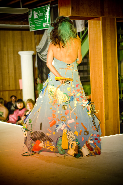 Host Rayona Visqueen wears a dress made of an air mattress (once slept on by Dwight from The Office) and decorated with nasty plastic plucked from the shores of Kanali Beach in Hawaii.