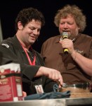 Emcee Tom Douglas eggs on chef Seth Caswell.