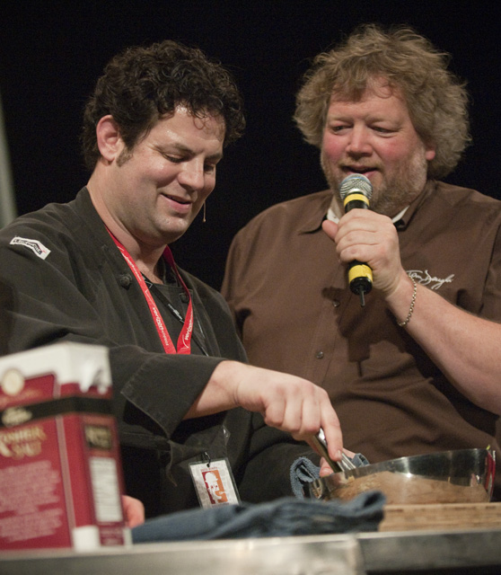 Emcee Tom Douglas eggs on chef Seth Caswell.