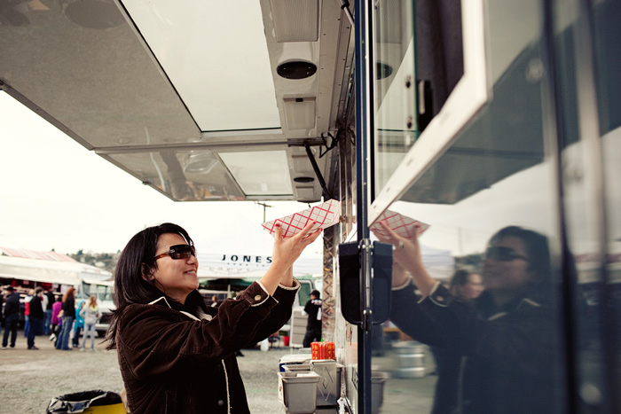 Lulu picks up her aloha pork slider & Kalbi beef taco.