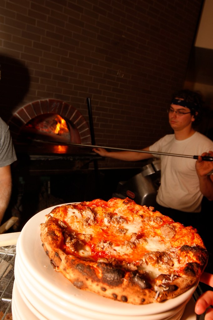 SEATTLE, WA FRIDAY OCT. 4, 2009 Delancey Pizza in Ballard Brandon Pettit unloads a pie from the wood burning oven at Delancey Pizza in Ballard. Pettit owns the restaurant with wife Molly Wizenberg. Photos by Kevin Casey/Seattle Weekly