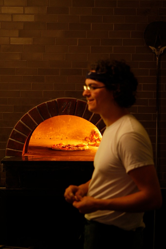SEATTLE, WA FRIDAY OCT. 4, 2009 Delancey Pizza in Ballard Brandon Pettit unloads a pie from the wood burning oven at Delancey Pizza in Ballard. Pettit owns the restaurant with wife Molly Wizenberg. Photos by Kevin Casey/Seattle Weekly