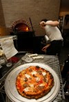 SEATTLE, WA FRIDAY OCT. 4, 2009 Delancey Pizza in Ballard Brandon Pettit unloads a pie from the wood burning oven at Delancey Pizza in Ballard. Pettit owns the restaurant with wife Molly Wizenberg. Photos by Kevin Casey/Seattle Weekly