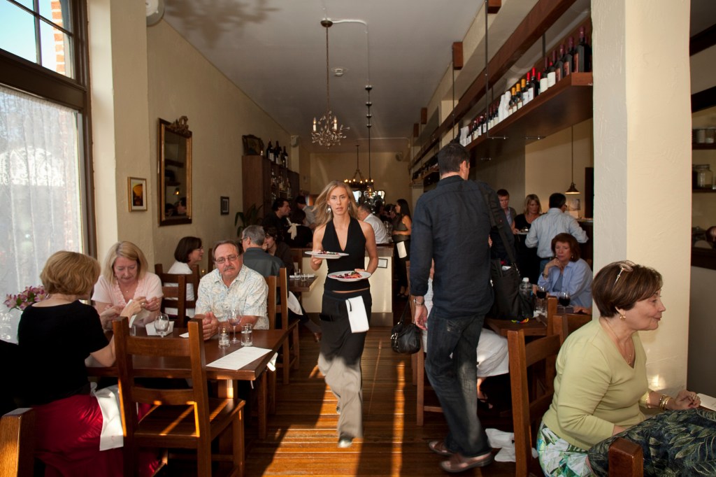 They've hired a photogenic pack of waiters to work the room.