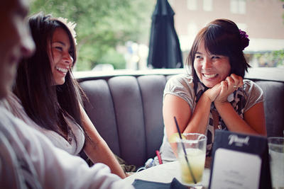 Persia and Sienna, promo girls at 9 Milli have drinks together after a staff meeting.