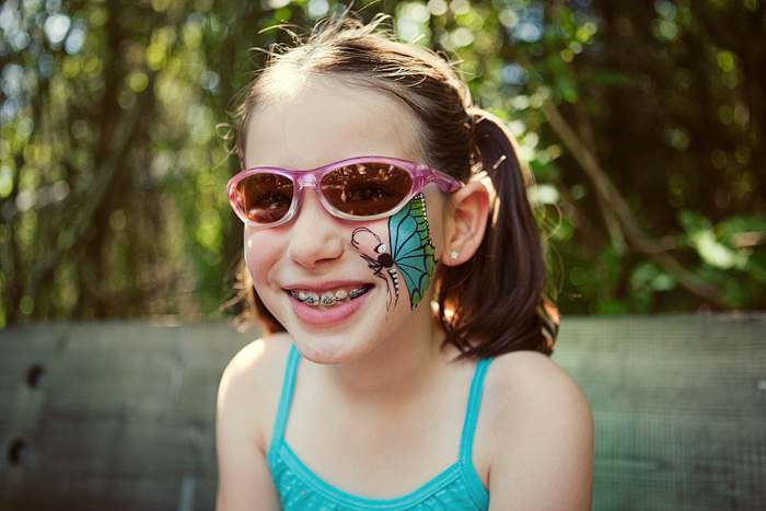 She had her face painted with a butterfly.