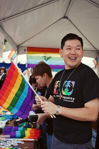 Chi sells parade merchandise for Out and Proud.