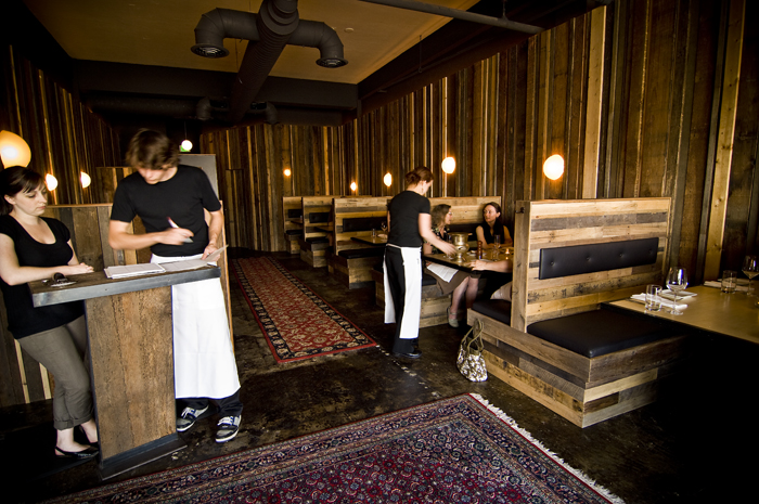 The Penns are also giving a nod to the classic American steakhouse, with its wood paneling, golden lighting, and leather booths, through Jacob and Lucas Mihoulides' decor.