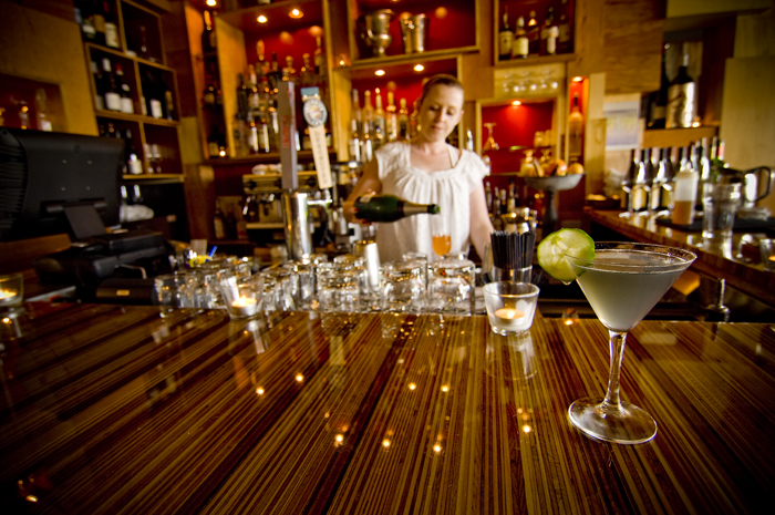 The walls of the Champagne Parlor section of the restaurant are covered in hundreds of unvarnished plywood squares that jut from the wall at varying heights, reminiscent of a Kurt Schwitters collage, while the Oyster House half is paneled vertically in the thin sides of raw two-by-fours.