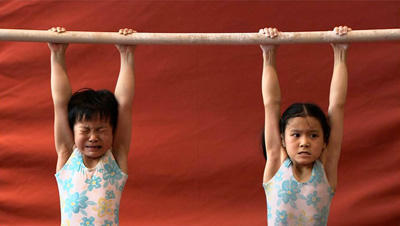 The Red Race: This is the best sports documentary to play SIFF since The Heart of the Game, one of the best IaE™ve seen in a decade. Granted unbelievable access by a Shanghai gymnastics academy (which likely thought the doc would boost its reputation), director Gan Chao follows several young children through their grueling workouts, schooling, and home life. WeaE™ve read about the fishy birth certificates China used for its gymnasts at the last Olympics, but what we see here is an intensely competitive and unforgiving feeder system that molds medal winners at a very young age. Their parents are poor, peasants displaced from the countryside, and their families arenaE™t always intact. Making each selection at the academy, scoring well in meets, and then possibly reaching the national team is a matter of economic advancement not just for the tiny athletes, but for their kin, too. For this reason, we can understand why so few of them cry or complain about the incessant work and stern coaches. One of whom scolds a kid, aEœIs crying useful? Can you win first place by crying?aE Yet these coaches arenaE™t monsters, and the academy isnaE™t exactly child abuse. Everyone knows the stakes involved, even the children (or they soon learn). There is a single, static shot in this movie, perhaps 60 seconds long, that contains more drama than anything IaE™ve seen on film this year: Two girls, aged about eight, in a contest to see who can hang longest from a bar. ItaE™s excruciating to watch, becauseaE”as both girls knowaE”the one who releases her grip first may drop farther than the floor.  (NR) REVIEW BY BRIAN MILLER SIFF Cinema: 7 p.m., Mon. June 8 (Also: 4:30 p.m. Thurs., June 11.)