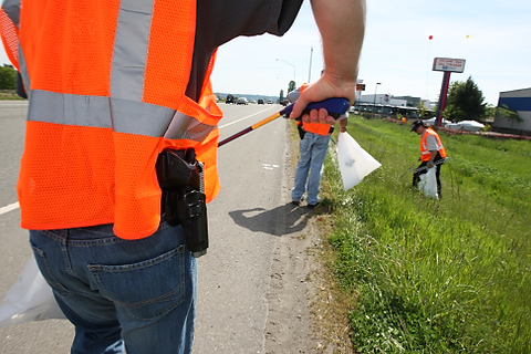 A group from OpenCarry.org pick up trash along their area along Interstate 5 Freeway near Fife as part of the Adopt-A-Highway program on Sunday, May 17, 2009. The group supports the right to carry a firearm . (Kevin P. Casey/Seattle Weekly)