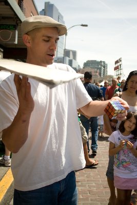 Street performers and musicians like the multitasking Ron mesmerizes those waiting for some cheese.