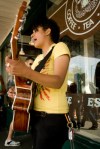 Whitney Monge serenades cheese goers outside the famous first Starbucks.