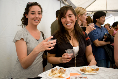 Kristin and Megan with a sampling under the wine tent.