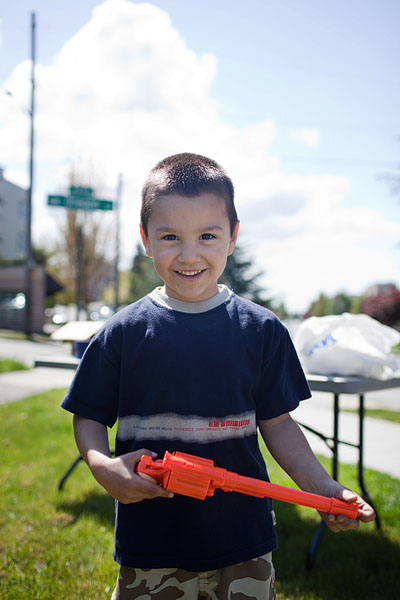 Angelo plays policeman with his plastic orange gun.