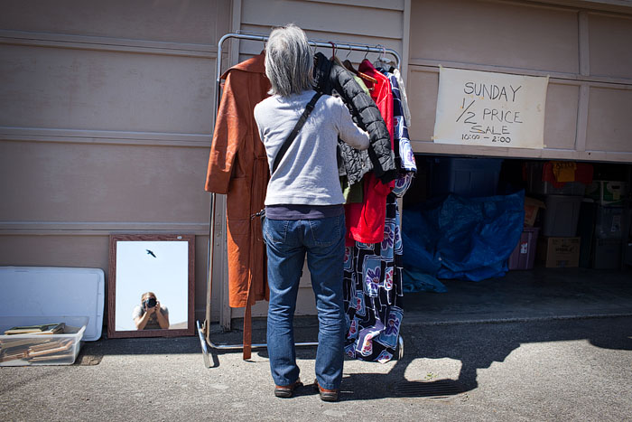 A promise of a Sunday markdown doesn't stop the shop for clothes.  Bonus points if you spot the photog!