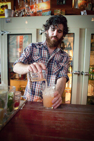 Will pours fresh squeezed grapefruit juice at Sun Liquor.