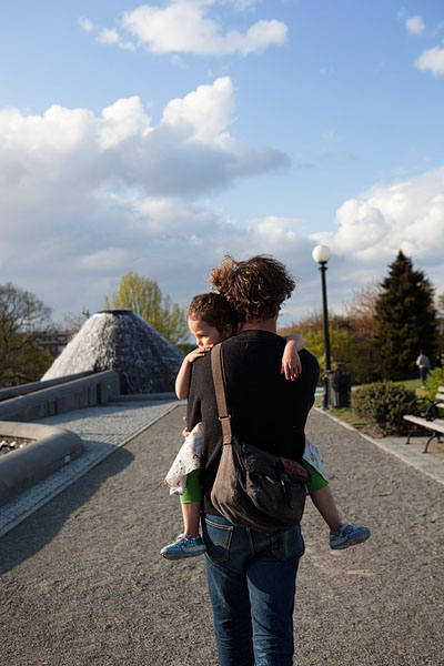 Tired tot takes a stroll with her dad.