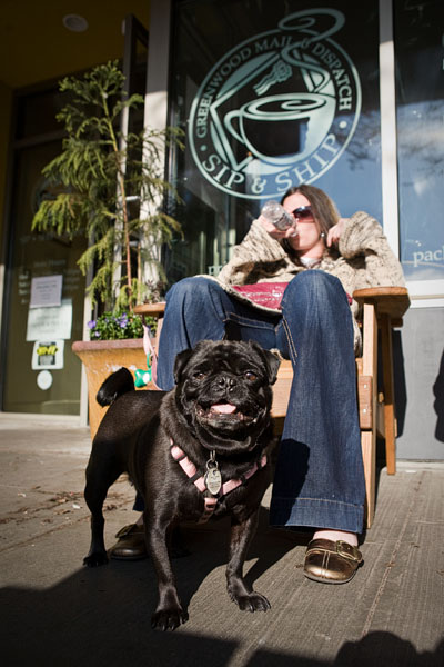 Petunia the Pug and her owner, Gina, have a sip outside the Greenwood Mail & Dispatch Sip & Ship.