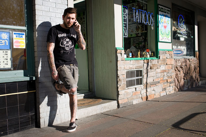 Matt, an apprentice at Emerald City Tattoo, takes a break.