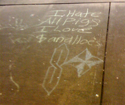 Temporary Capitol Hill sidewalk scrawlings hate on cops.