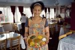 Belaynesh Chera, General Manager of Meskel serves up an Ethiopian dish in the Central District.