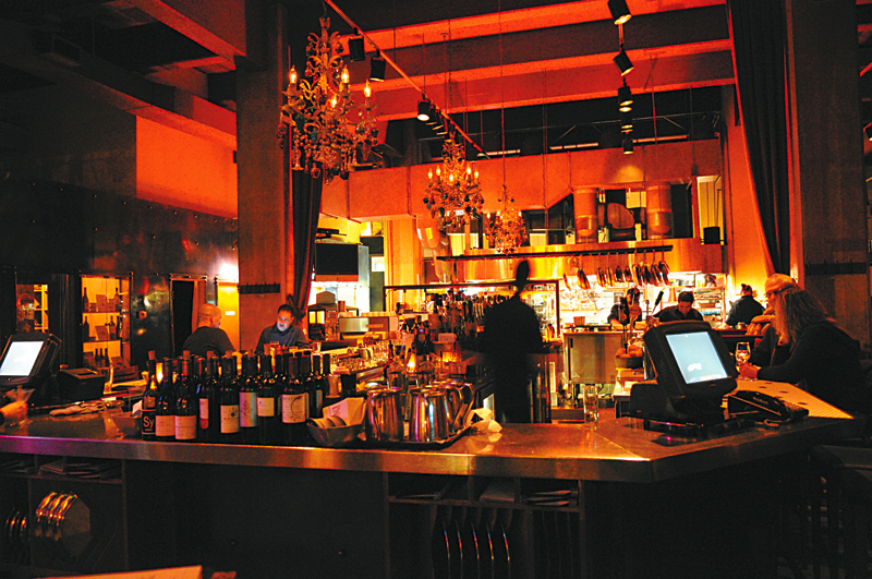 Palace Kitchen: EverythingaE™s big at Palace Kitchen: the ceilings, Boeing-hangar high. The mural along the south wall, which seems to depict the entire history of the Western hemisphere. The U-shaped bar, where a hundred Pee Wee Hermans could do the aEœTequila!aE dance. The famous crouton on the Caesar salad. We all feel ourselves bigger, when dining at the Palace, as if weaE™re protagonists in our own urban epic. In the kitchen, Tom Douglas and his crew swagger with as much flair as they always haveaE”serving up brawny whole chicken wings that have been marinated in soy and spice, then grilled over a wood fire; crinkle-edged plin (a type of agnolotti pasta) fat with ground pork and cabbage; an endive-apple-hazelnut aEœwhiteaE salad with a multivalent crunch. ItaE™s the perfect food to either complement the bartendersaE™ potent cocktails or soak up the three youaE™ve downed before determining a midnight feast was in order. Note by JONATHAN KAUFFMAN; Serves: dinner, late night. 2030 Fifth Ave., 448-2001, BELLTOWN., tomdouglas.com/restaurants/palace-kitchen