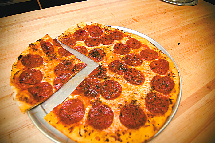 Veraci Pizza: When Veraci started wheeling a wood-burning clay oven into farmers market parking lots, Seattle got in line. You could call it thin-crust pizza with a dog-and-pony showaE”and who wouldnaE™t like watching their dinner get twirled to toasty perfection by a fire god whose sole job is to coddle your pie? But with their newest oven, this one permanently installed well out of hand-warming reach in a former DominoaE™s, Veraci proves that their pizzas are more about flavor than fanfare. Layered with zingy sauces, topped with fresh, often local ingredients (think BeecheraE™s cheese and mole salami), and usually kissed with a few fat blisters, VeraciaE™s pies deserve the cult status theyaE™re developing in North Seattle. Course, thereaE™s still a line. Call your order in ahead to cut the weekend wait from excruciating to annoying. JESS THOMSON; Serves: Lunch, dinner. FarmeraE™s markets or 500 N.W. Market St., 525-1813. BALLARD, veracipizza.com