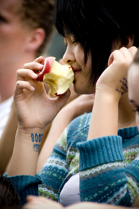Enjoying the music... and an apple.