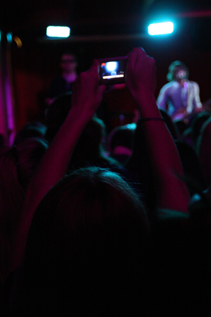 A fan raises up her camera to snap a picture of the band. We like to keep our fans happy, said Carmine. We definitely toured in Europe more than America on this record cycle.