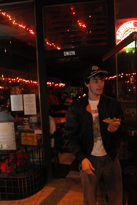 12:16:  A guy comes out of Flowers, a vegetarian bar that's not that cool, with a slice of pizza.