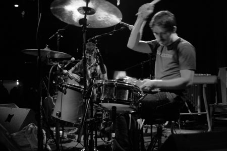 Logan Kroeber works on the drums and a tambourine during The Dodos performance.