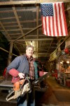 Tim Sheldon shows off the “toys” he stores in the shed he built on his Mason County tree farm.