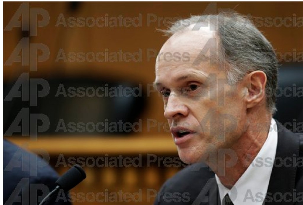 Dressed in worn jeans, a sweatshirt, and a camouflage cap, Senator Tim